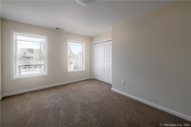 22 Lombard Cir Unit 22, North Haven, CT 06473 - unfurnished bedroom featuring carpet and a closet