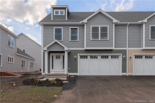 22 Lombard Cir Unit 22, North Haven, CT 06473 - view of front facade featuring a garage, driveway, and a shingled roof
