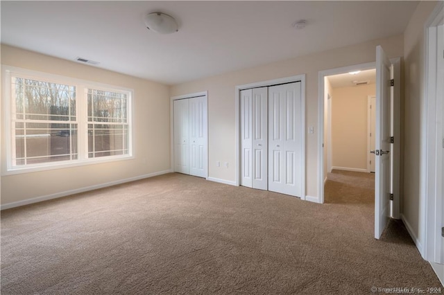 20 Lombard Cir Unit 20, North Haven, CT 06473 - unfurnished bedroom featuring carpet flooring and two closets