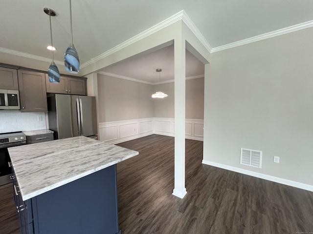 20 Lombard Cir Unit 20, North Haven, CT 06473 - kitchen featuring appliances with stainless steel finishes, dark wood-style floors, a kitchen island, decorative light fixtures, and a wainscoted wall