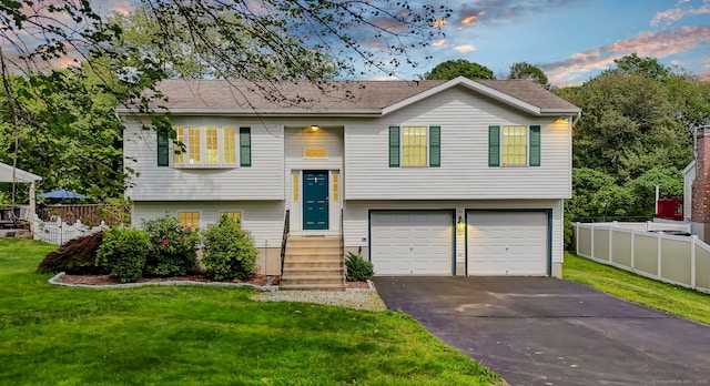 285 Witches Rock Rd, Bristol, CT 06010 - split foyer home featuring a garage, asphalt driveway, and entry steps