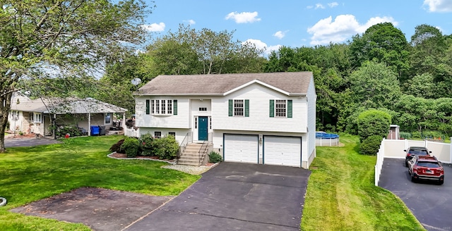 285 Witches Rock Rd, Bristol, CT 06010 - bi-level home featuring asphalt driveway, an attached garage, a front lawn, and roof with shingles