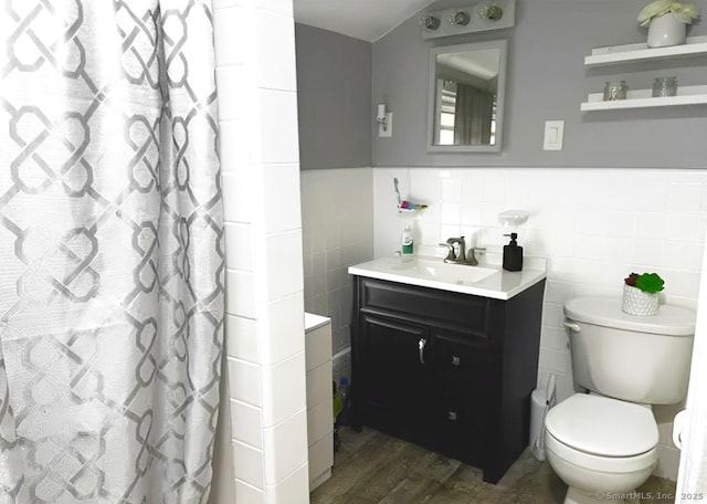92 Curtiss St, Naugatuck, CT 06770 - full bathroom featuring wood finished floors, vanity, tile walls, toilet, and wainscoting