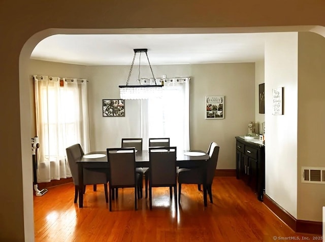 92 Curtiss St, Naugatuck, CT 06770 - dining area with arched walkways, dark wood-type flooring, and baseboards