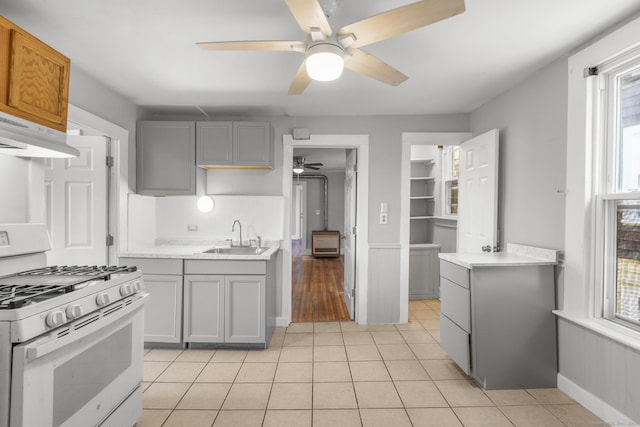 480 W St, Bristol, CT 06010 - kitchen with white range with gas stovetop, ceiling fan, under cabinet range hood, and gray cabinets