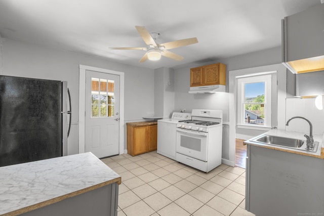 480 W St, Bristol, CT 06010 - kitchen featuring white range with gas stovetop, freestanding refrigerator, under cabinet range hood, and plenty of natural light