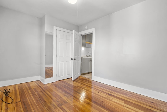 480 W St, Bristol, CT 06010 - unfurnished bedroom with baseboards and wood-type flooring