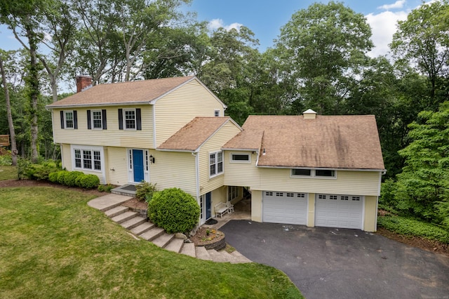 19 W Hills Rd, Essex, CT 06442 - colonial-style house with a chimney, asphalt driveway, a front lawn, roof with shingles, and an attached garage