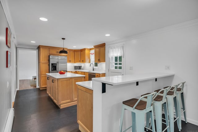 19 W Hills Rd, Essex, CT 06442 - kitchen with stainless steel appliances, a baseboard heating unit, crown molding, light countertops, and a kitchen island