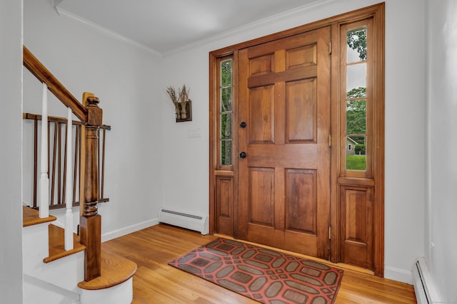 19 W Hills Rd, Essex, CT 06442 - foyer with a baseboard heating unit, light wood-style flooring, stairs, and crown molding