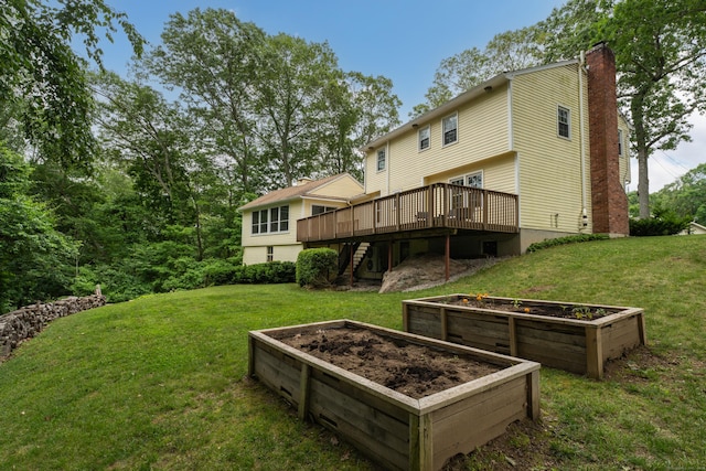 19 W Hills Rd, Essex, CT 06442 - view of green lawn with a wooden deck, a vegetable garden, and stairs