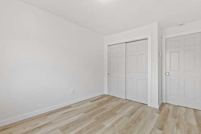 17 Avon Ln, Stamford, CT 06907 - unfurnished bedroom with light wood-type flooring, a closet, and baseboards