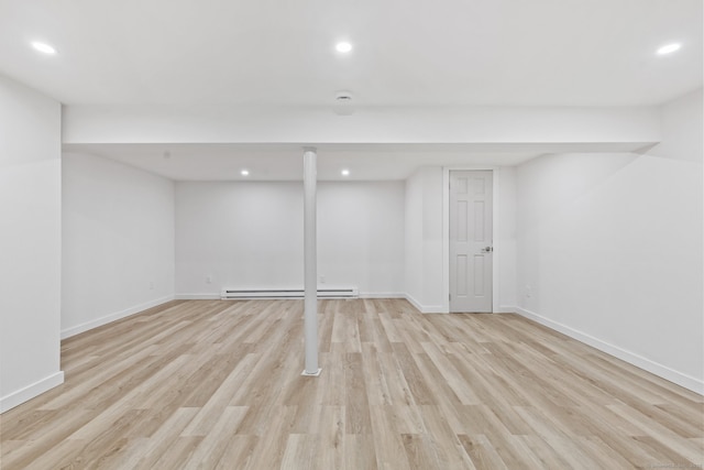 17 Avon Ln, Stamford, CT 06907 - finished basement with a baseboard radiator, light wood-style floors, recessed lighting, and baseboards