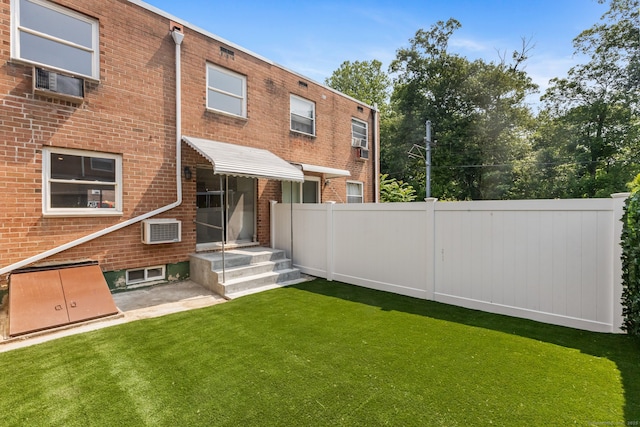 17 Avon Ln, Stamford, CT 06907 - back of house with brick siding and a wall unit AC