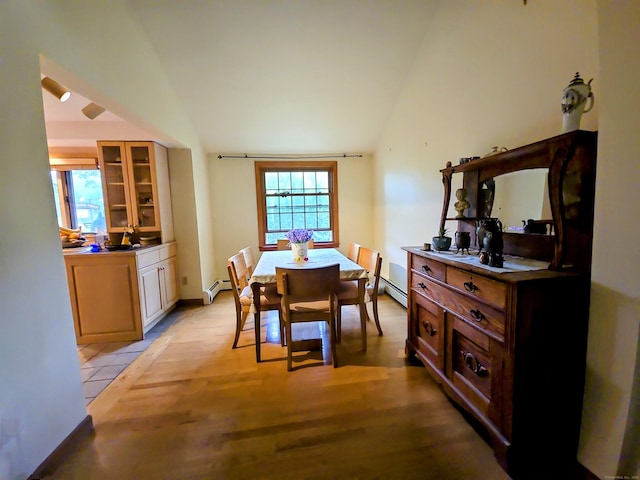 44 Wilbur Rd, Washington, CT 06777 - dining room with vaulted ceiling, light wood-style floors, and a baseboard heating unit