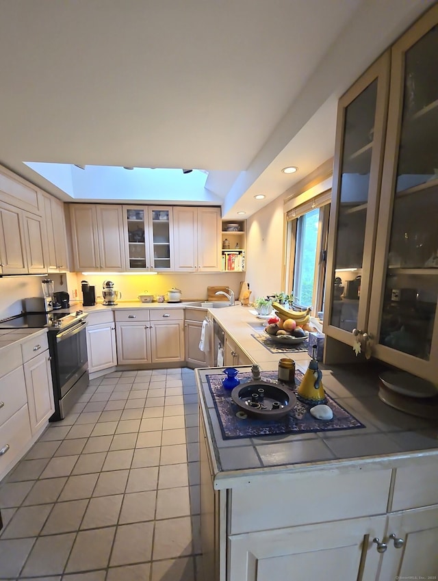 44 Wilbur Rd, Washington, CT 06777 - kitchen with light tile patterned floors, a sink, glass insert cabinets, stainless steel range with electric cooktop, and recessed lighting