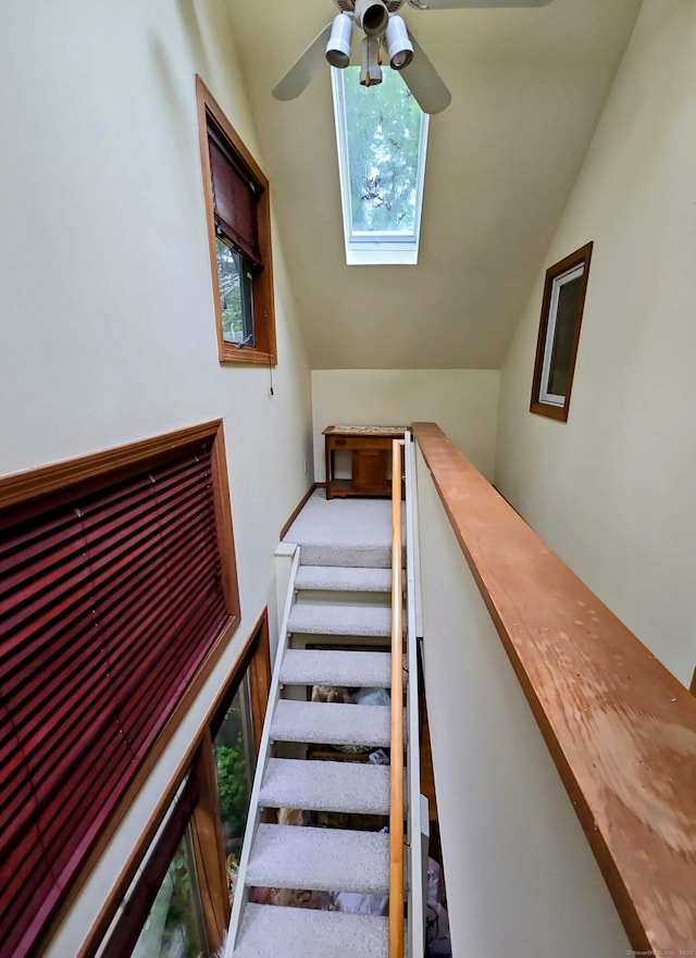 44 Wilbur Rd, Washington, CT 06777 - staircase with vaulted ceiling, a skylight, and a ceiling fan