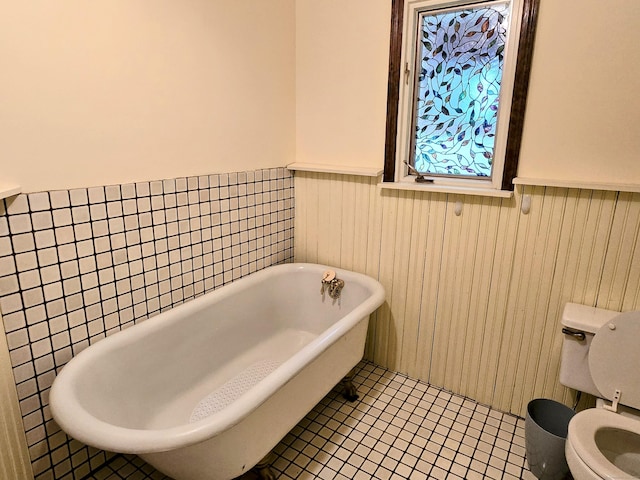 44 Wilbur Rd, Washington, CT 06777 - bathroom featuring wainscoting, a soaking tub, toilet, and tile patterned floors