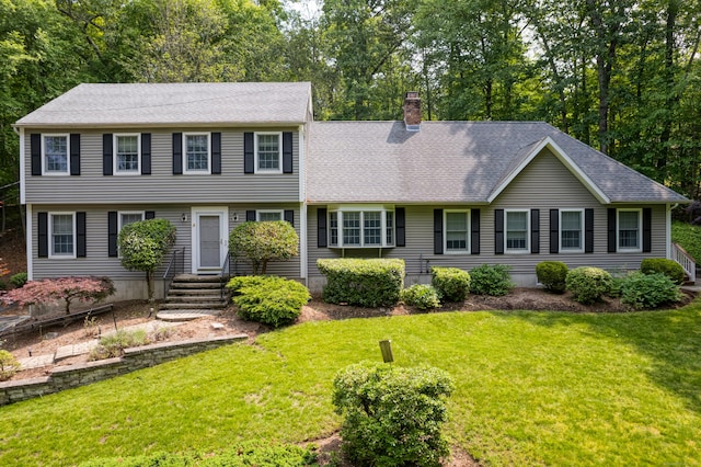 35 Whitethorn Dr, Guilford, CT 06437 - colonial-style house with a chimney, a front lawn, and roof with shingles