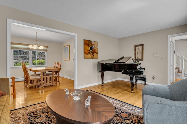 35 Whitethorn Dr, Guilford, CT 06437 - living room with light wood-style flooring, a chandelier, stairway, and baseboards