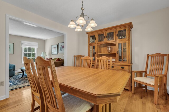 35 Whitethorn Dr, Guilford, CT 06437 - dining area with a chandelier and light wood-style floors