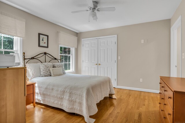 35 Whitethorn Dr, Guilford, CT 06437 - bedroom with light wood-type flooring, a closet, baseboards, and a ceiling fan