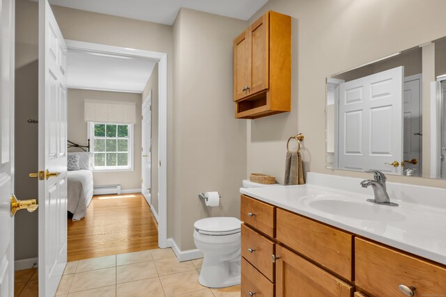 35 Whitethorn Dr, Guilford, CT 06437 - bathroom featuring baseboard heating, vanity, tile patterned flooring, toilet, and baseboards