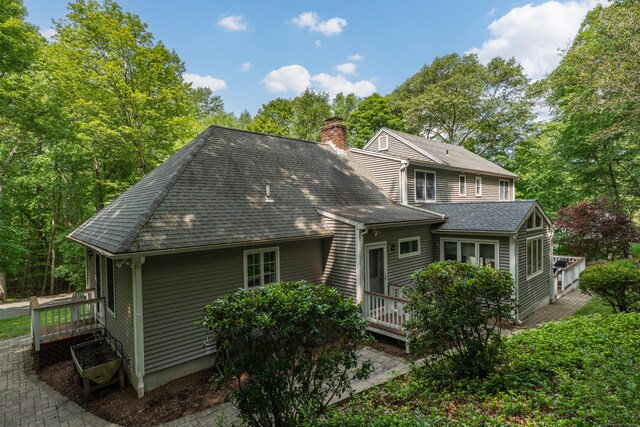 35 Whitethorn Dr, Guilford, CT 06437 - back of house with a deck, a chimney, and a shingled roof