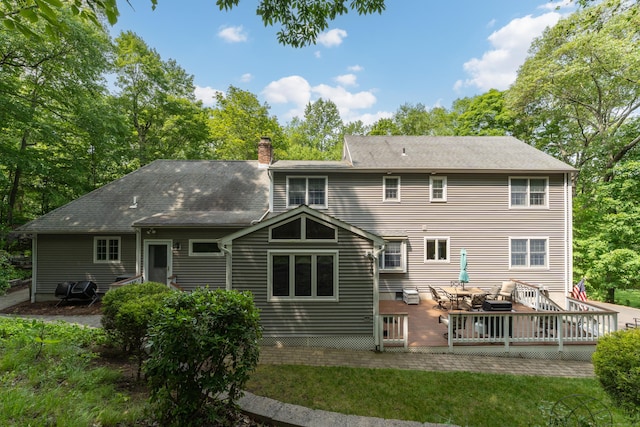 35 Whitethorn Dr, Guilford, CT 06437 - back of house featuring a chimney, a deck, and a shingled roof