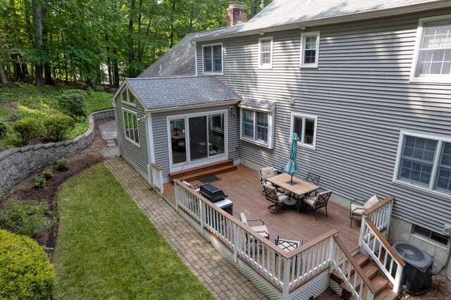 35 Whitethorn Dr, Guilford, CT 06437 - rear view of house with outdoor dining area, a deck, a chimney, roof with shingles, and a yard