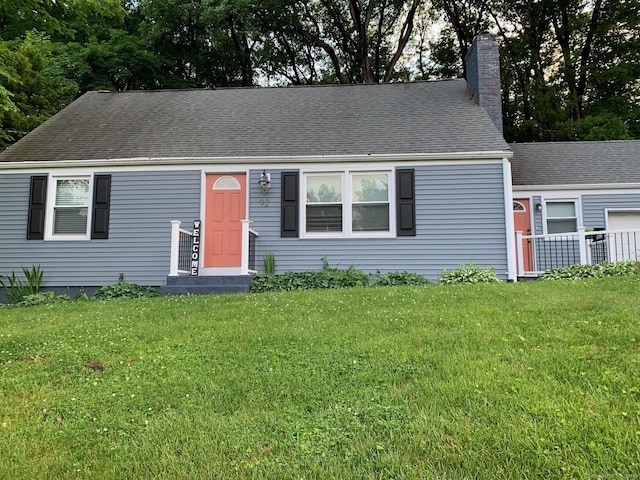 92 Jones Dr, New Britain, CT 06053 - view of front of house with a front lawn, a chimney, and roof with shingles