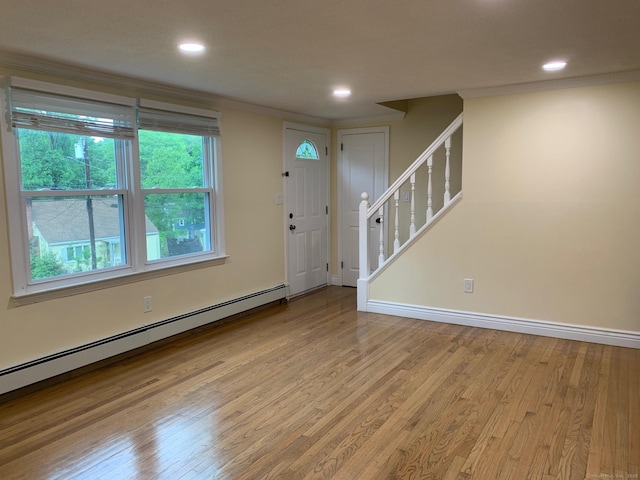 92 Jones Dr, New Britain, CT 06053 - entrance foyer with a baseboard radiator, wood finished floors, ornamental molding, stairway, and baseboards