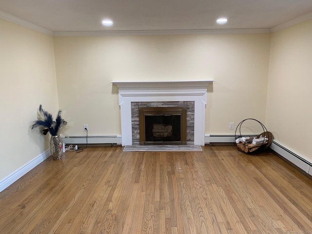 92 Jones Dr, New Britain, CT 06053 - unfurnished living room featuring ornamental molding, baseboard heating, a fireplace with raised hearth, wood finished floors, and recessed lighting