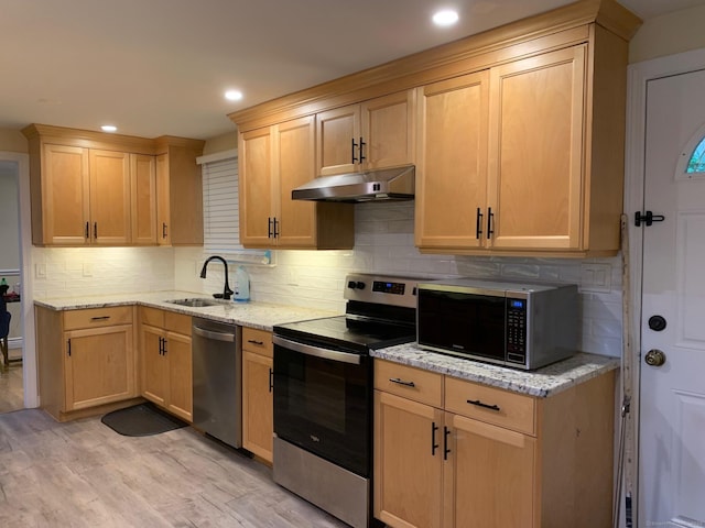 92 Jones Dr, New Britain, CT 06053 - kitchen featuring appliances with stainless steel finishes, under cabinet range hood, a sink, light brown cabinets, and light wood-style floors