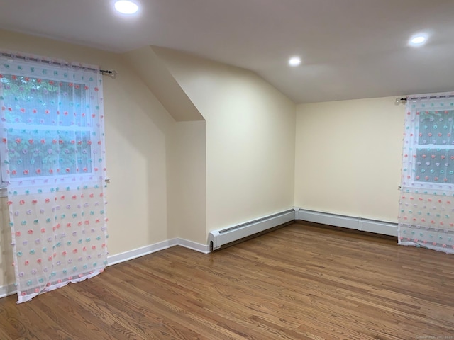 92 Jones Dr, New Britain, CT 06053 - additional living space with wood finished floors, recessed lighting, baseboards, lofted ceiling, and a baseboard radiator