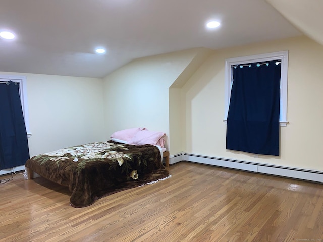 92 Jones Dr, New Britain, CT 06053 - bedroom with baseboard heating, wood finished floors, lofted ceiling, and recessed lighting