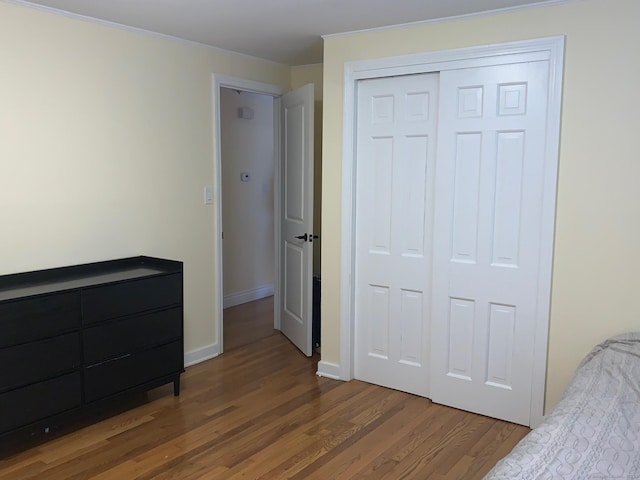 92 Jones Dr, New Britain, CT 06053 - unfurnished bedroom with wood finished floors, a closet, baseboards, and crown molding