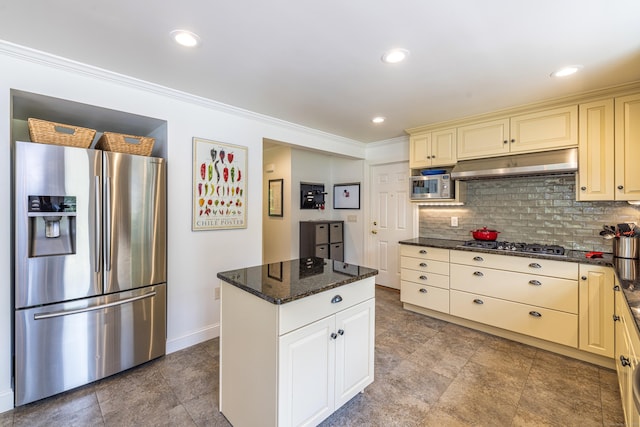 47 Davis Rd, Mansfield, CT 06268 - kitchen with stainless steel appliances, under cabinet range hood, cream cabinetry, tasteful backsplash, and crown molding