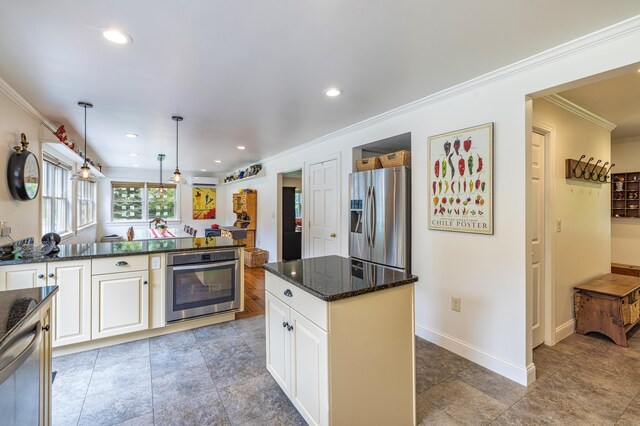 47 Davis Rd, Mansfield, CT 06268 - kitchen featuring appliances with stainless steel finishes, ornamental molding, dark stone counters, pendant lighting, and white cabinetry