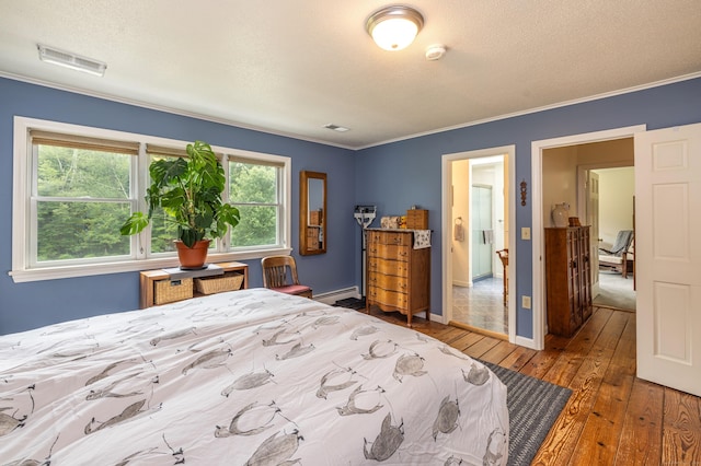47 Davis Rd, Mansfield, CT 06268 - bedroom with hardwood / wood-style floors, crown molding, a textured ceiling, and a baseboard heating unit