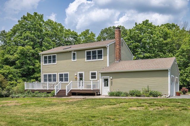 47 Davis Rd, Mansfield, CT 06268 - back of house with a chimney, a wooden deck, a yard, a garage, and roof with shingles
