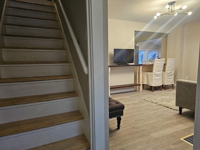 262 Meyer Rd, Torrington, CT 06790 - staircase featuring wood finished floors and a chandelier