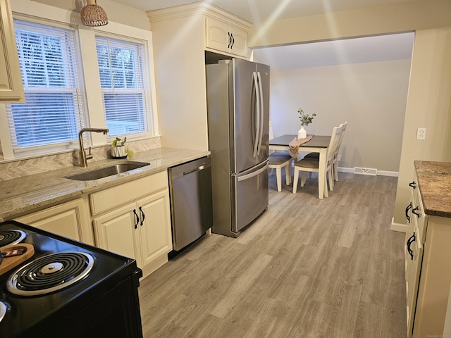 262 Meyer Rd, Torrington, CT 06790 - kitchen with stainless steel appliances, light wood-style floors, and light stone counters
