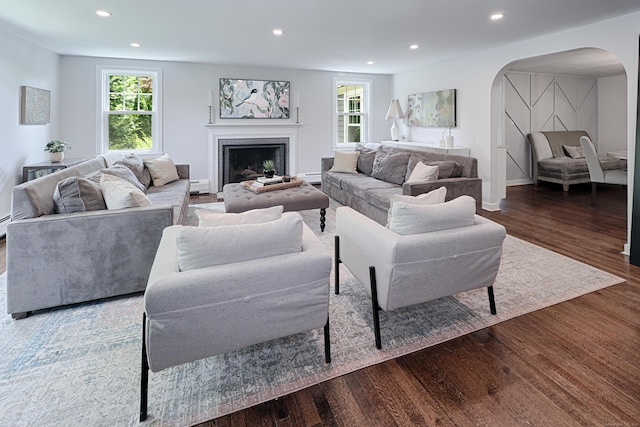 29 Bayberry Rd, Fairfield, CT 06825 - living room with arched walkways, wood finished floors, recessed lighting, a fireplace, and a baseboard radiator