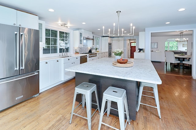29 Bayberry Rd, Fairfield, CT 06825 - kitchen featuring appliances with stainless steel finishes, a chandelier, a breakfast bar, a center island, and recessed lighting