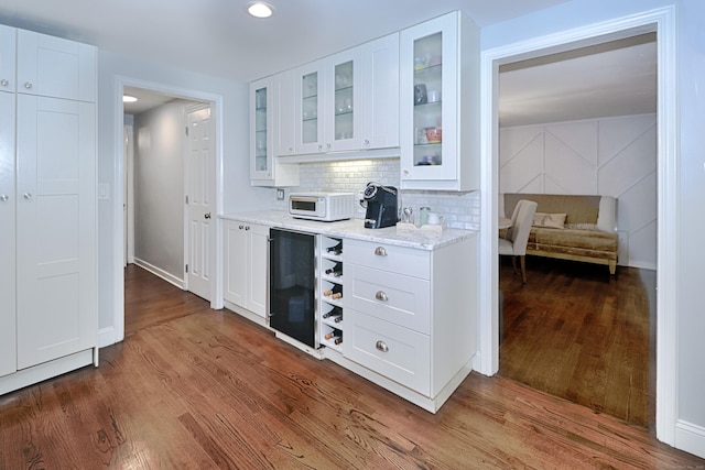 29 Bayberry Rd, Fairfield, CT 06825 - bar with dark wood-style flooring, decorative backsplash, refrigerator, and recessed lighting