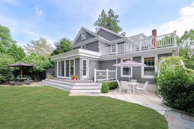 29 Bayberry Rd, Fairfield, CT 06825 - back of house featuring a balcony, a patio, a lawn, and a chimney
