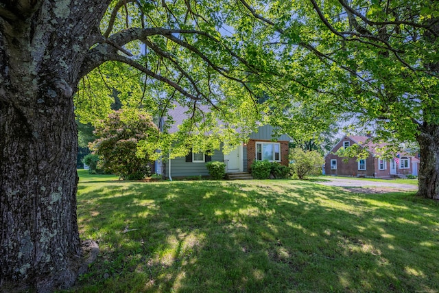 824 Torringford W St, Torrington, CT 06790 - view of front of house featuring brick siding and a front lawn