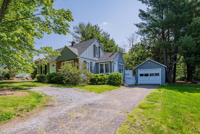 824 Torringford W St, Torrington, CT 06790 - view of front of house with asphalt driveway, a garage, an outdoor structure, a front lawn, and a chimney