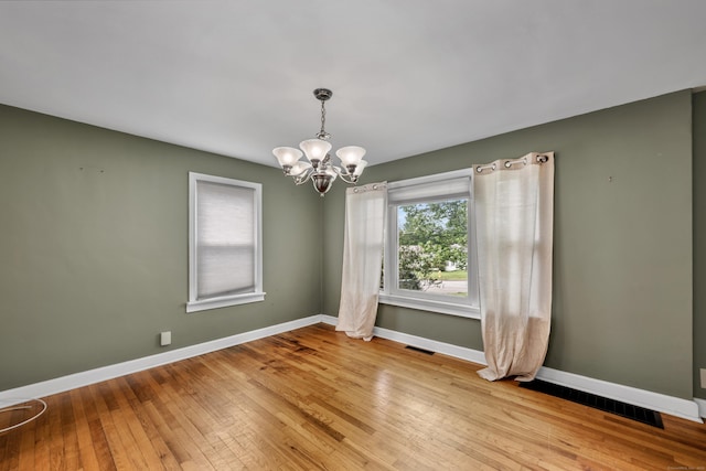 824 Torringford W St, Torrington, CT 06790 - unfurnished room featuring a chandelier and light wood-style flooring